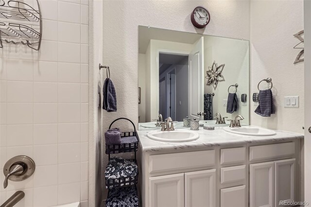 15211 Quince St, Thornton, CO 80602 - bathroom featuring double vanity and a textured wall