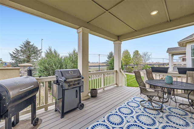 15211 Quince St, Thornton, CO 80602 - wooden terrace featuring a grill, fence, and outdoor dining space