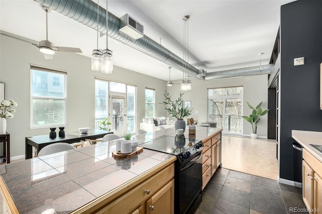 2501 15th St Unit 2C, Denver, CO 80211 - kitchen featuring electric range, tile countertops, stone tile flooring, open floor plan, and decorative light fixtures