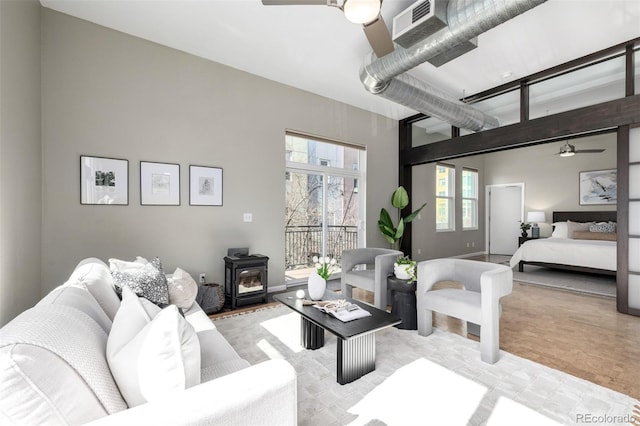 2501 15th St Unit 2C, Denver, CO 80211 - living area with a ceiling fan, a wood stove, and a towering ceiling