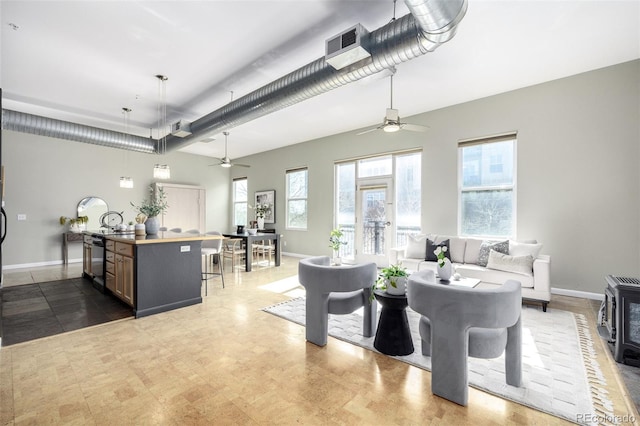 2501 15th St Unit 2C, Denver, CO 80211 - living room with ceiling fan and a wood stove