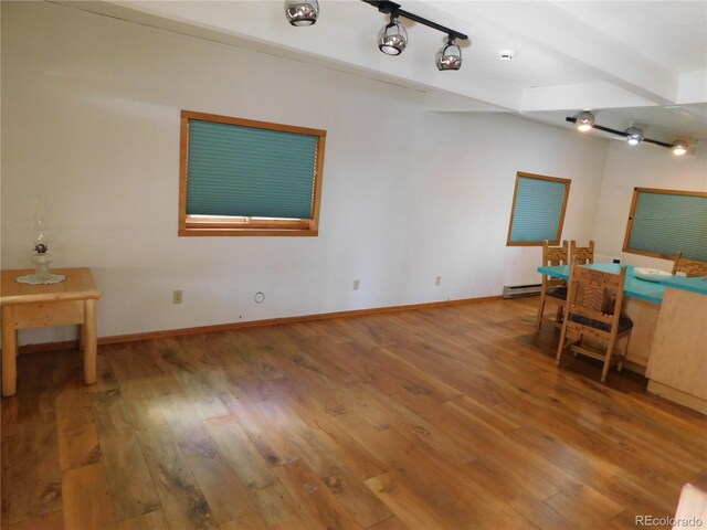 11003 US Highway 160, Del Norte, CO 81132 - unfurnished office with wood finished floors, a baseboard radiator, and baseboards