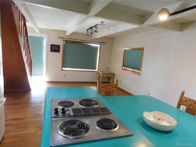 11003 US Highway 160, Del Norte, CO 81132 - kitchen with beam ceiling, stove, wood finished floors, and baseboards