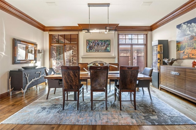 dining area with hardwood / wood-style flooring and ornamental molding