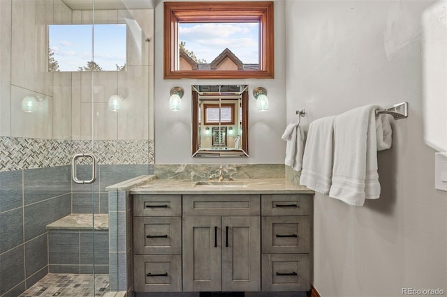 bathroom with vanity and a shower with door