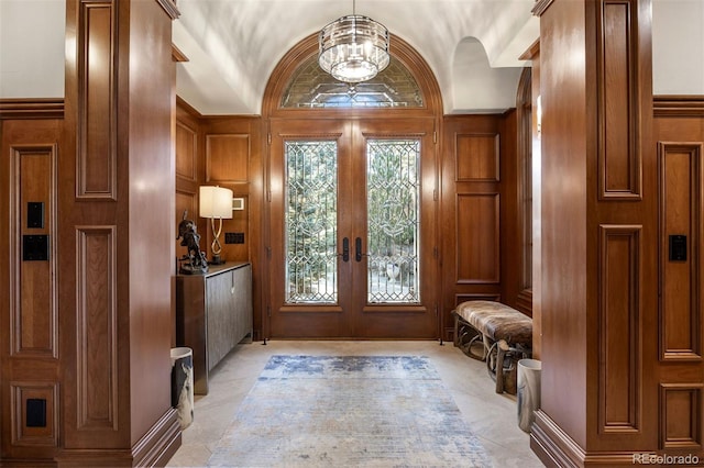 entrance foyer featuring french doors and vaulted ceiling