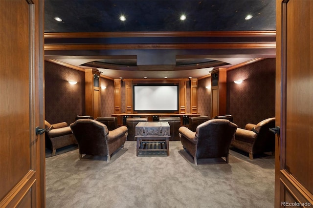 home theater room featuring carpet floors, ornamental molding, and ornate columns