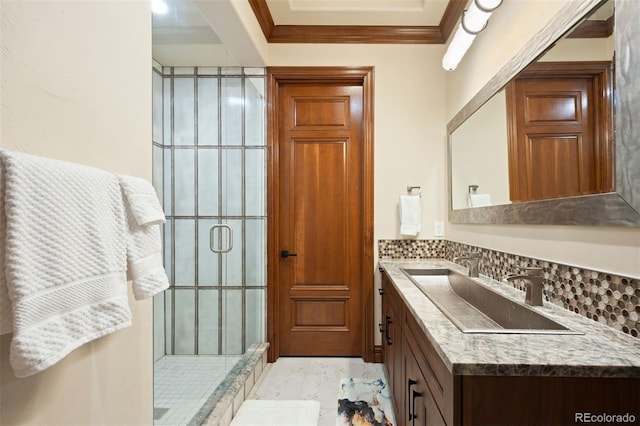 bathroom featuring vanity, crown molding, a stall shower, and decorative backsplash