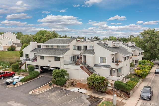 1820 Newland Ct Unit 310, Lakewood, CO 80214 - view of building exterior with uncovered parking, a residential view, and stairway