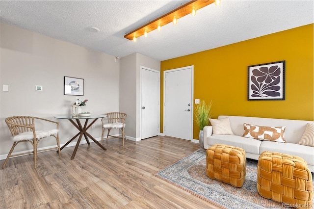 1820 Newland Ct Unit 310, Lakewood, CO 80214 - living area featuring wood finished floors, a textured ceiling, and baseboards
