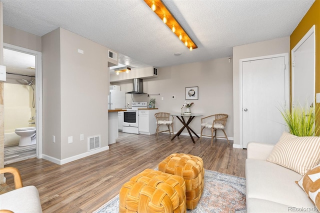 1820 Newland Ct Unit 310, Lakewood, CO 80214 - living area with wood finished floors, a textured ceiling, and baseboards
