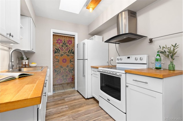 1820 Newland Ct Unit 310, Lakewood, CO 80214 - kitchen featuring white appliances, wood counters, island range hood, and a sink