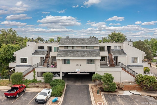 1820 Newland Ct Unit 310, Lakewood, CO 80214 - view of building exterior featuring stairs and uncovered parking