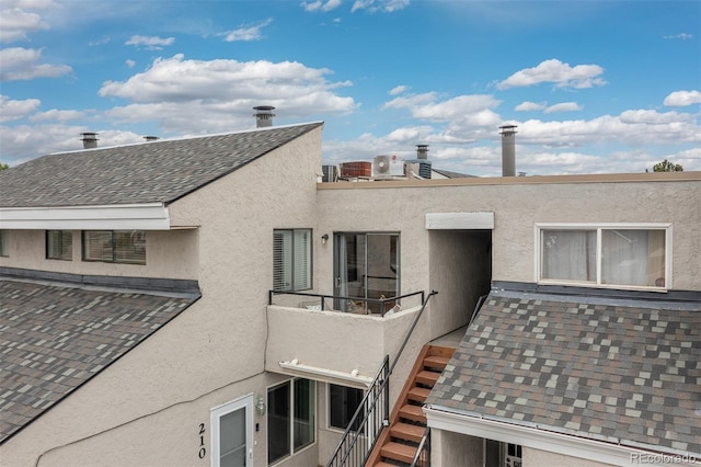 1820 Newland Ct Unit 310, Lakewood, CO 80214 - view of side of property with a shingled roof and stucco siding