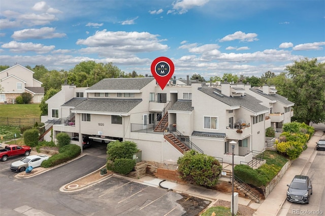 1820 Newland Ct Unit 310, Lakewood, CO 80214 - view of property with uncovered parking, a residential view, and stairs
