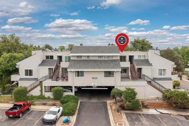 1820 Newland Ct Unit 310, Lakewood, CO 80214 - view of building exterior featuring stairs and uncovered parking