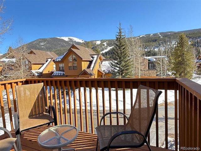 snow covered deck featuring a mountain view