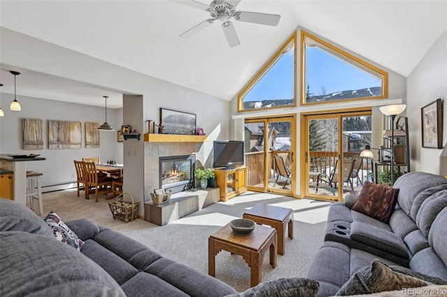 carpeted living room with a baseboard radiator, high vaulted ceiling, ceiling fan, and a fireplace