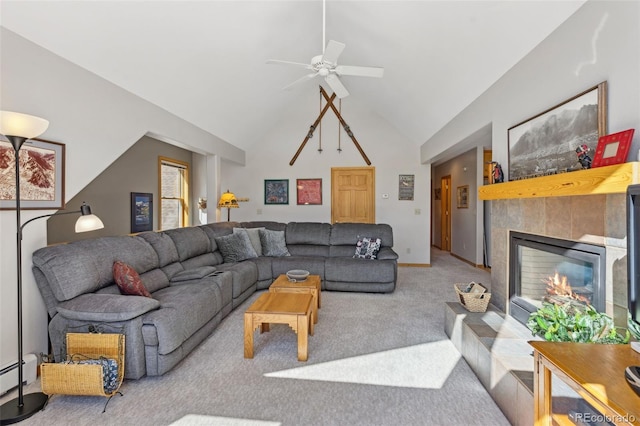 living area featuring a ceiling fan, carpet floors, high vaulted ceiling, a tile fireplace, and baseboard heating