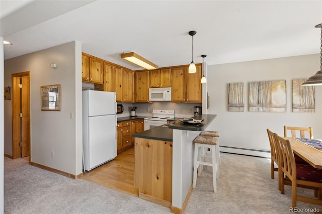 kitchen featuring dark countertops, light colored carpet, a peninsula, white appliances, and a baseboard radiator