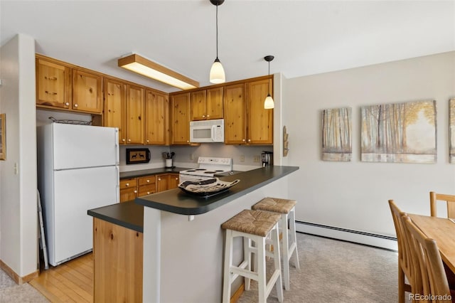 kitchen featuring a kitchen breakfast bar, dark countertops, white appliances, a peninsula, and baseboard heating