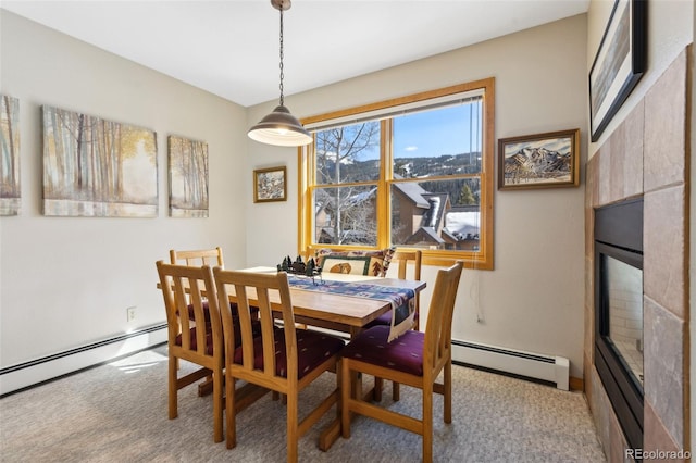 dining room with light carpet and a baseboard radiator