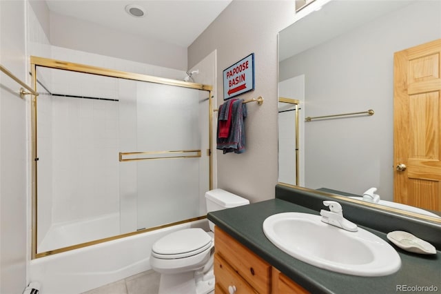 bathroom featuring tub / shower combination, toilet, vanity, and tile patterned flooring