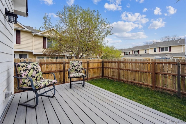 wooden terrace featuring a residential view and fence