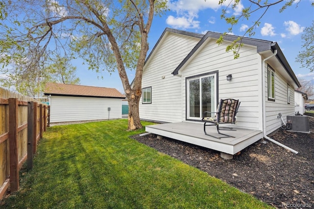 back of house featuring a wooden deck, a fenced backyard, central AC, and a lawn