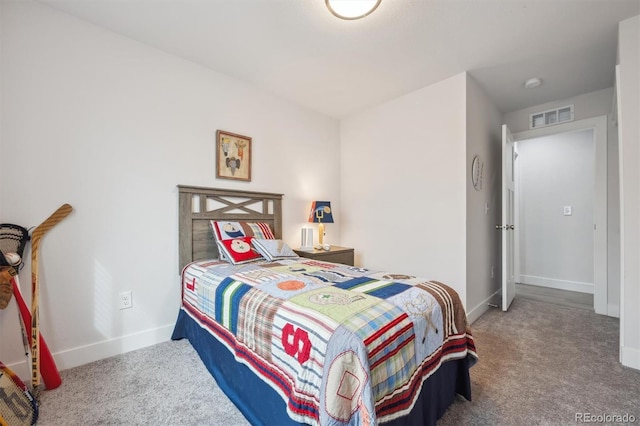 carpeted bedroom featuring baseboards and visible vents