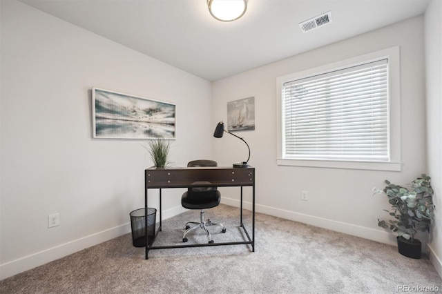 carpeted office space with baseboards and visible vents
