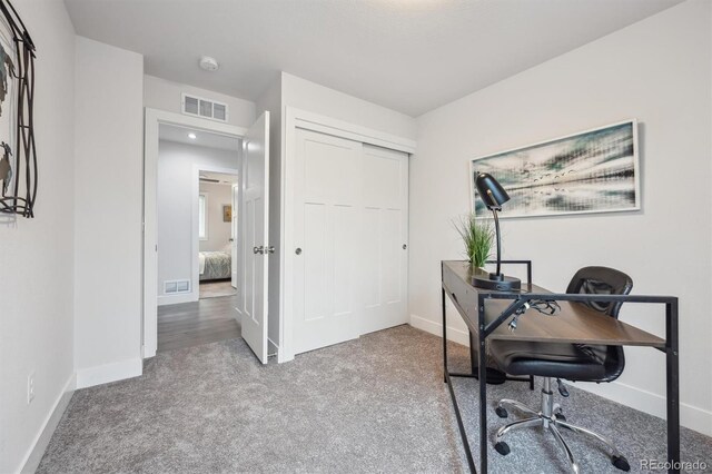carpeted office featuring baseboards and visible vents