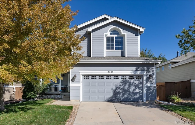 front facade with a garage and a front lawn