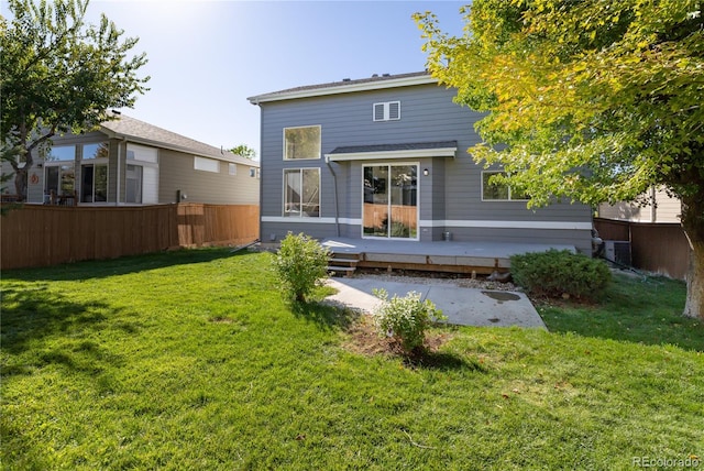 rear view of property with a yard and a deck