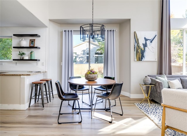 dining room featuring light wood-type flooring and a chandelier