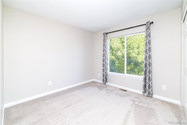 unfurnished room featuring carpet