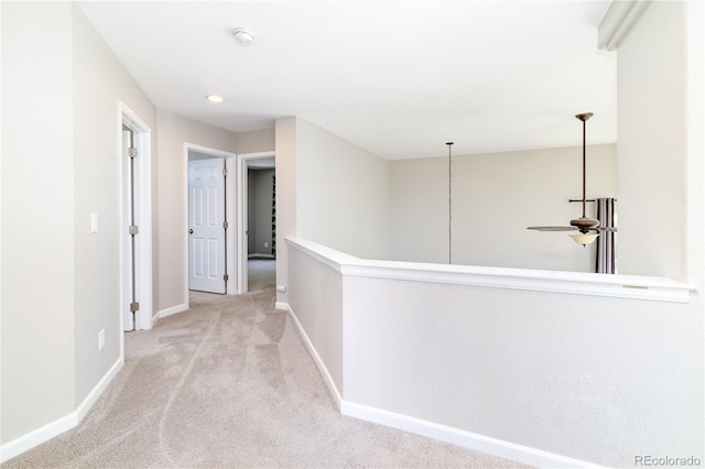 corridor featuring light colored carpet