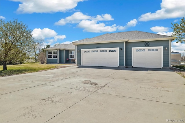 56330 E 37th Ct, Strasburg, CO 80136 - ranch-style home featuring concrete driveway, a front lawn, and a garage