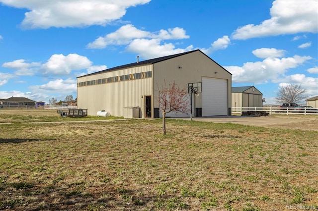 56330 E 37th Ct, Strasburg, CO 80136 - view of pole building with fence and a yard