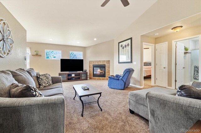 56330 E 37th Ct, Strasburg, CO 80136 - living room featuring carpet, a tiled fireplace, a ceiling fan, and baseboards