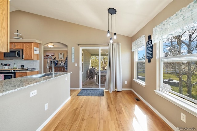 56330 E 37th Ct, Strasburg, CO 80136 - unfurnished dining area with lofted ceiling, visible vents, a sink, and light wood finished floors