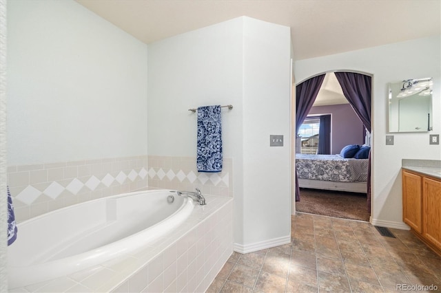 56330 E 37th Ct, Strasburg, CO 80136 - ensuite bathroom with a bath, baseboards, ensuite bath, and vanity