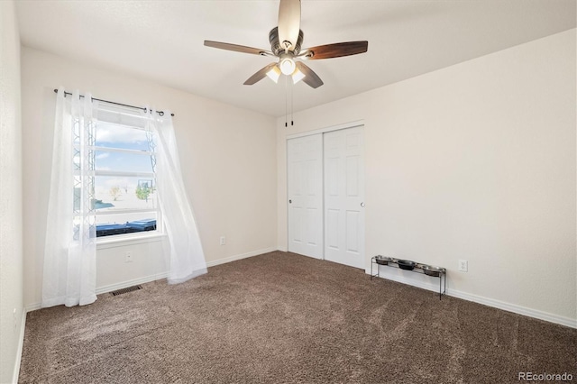 56330 E 37th Ct, Strasburg, CO 80136 - unfurnished bedroom with carpet, visible vents, a closet, baseboards, and ceiling fan