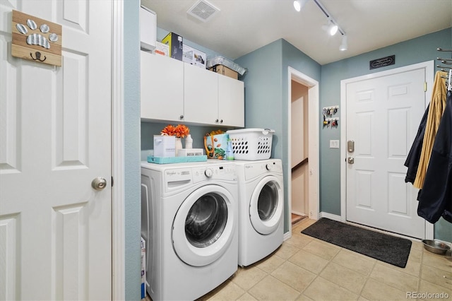 56330 E 37th Ct, Strasburg, CO 80136 - washroom featuring track lighting, visible vents, light tile patterned floors, washer and dryer, and cabinet space