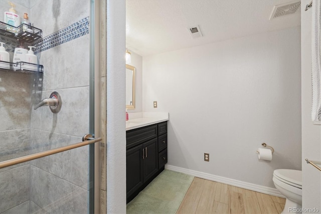 56330 E 37th Ct, Strasburg, CO 80136 - full bathroom featuring visible vents, vanity, a stall shower, and toilet