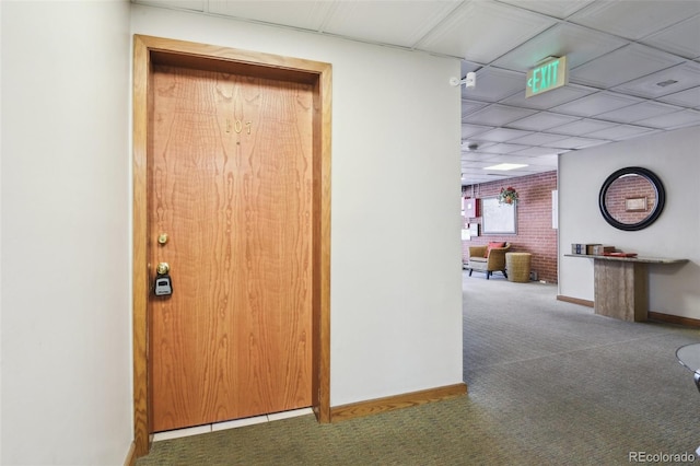 hallway with carpet floors and baseboards