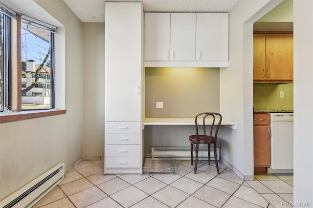 kitchen featuring built in study area, a baseboard radiator, white cabinetry, and white dishwasher