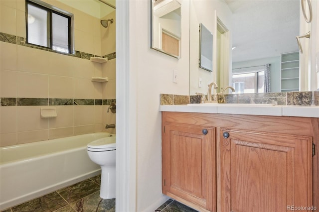 bathroom with shower / bath combination, vanity, and toilet