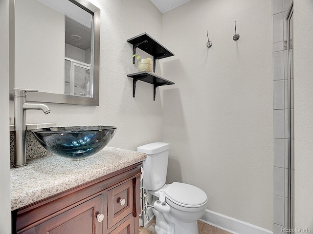 bathroom with vanity, an enclosed shower, tile patterned floors, and toilet