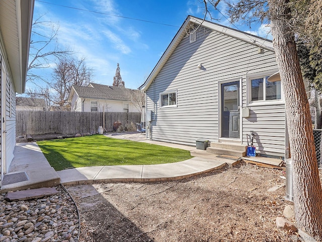 back of house featuring a patio and a lawn